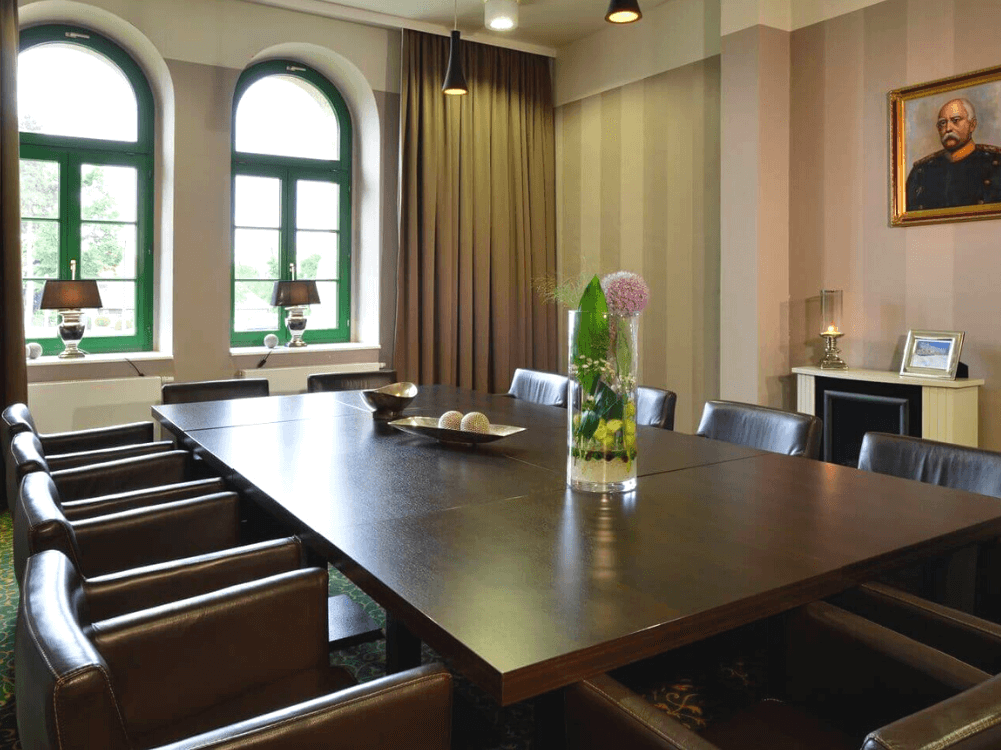 Großer Tisch mit Stühlen im Herrenzimmer