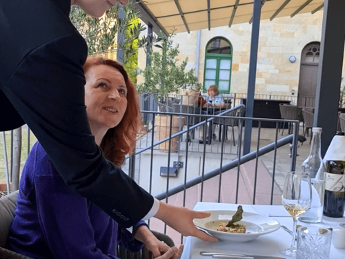 Tagungsgast, dem auf der Terrasse ein Essen serviert wird